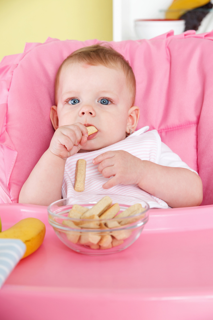 Cute baby eating alone